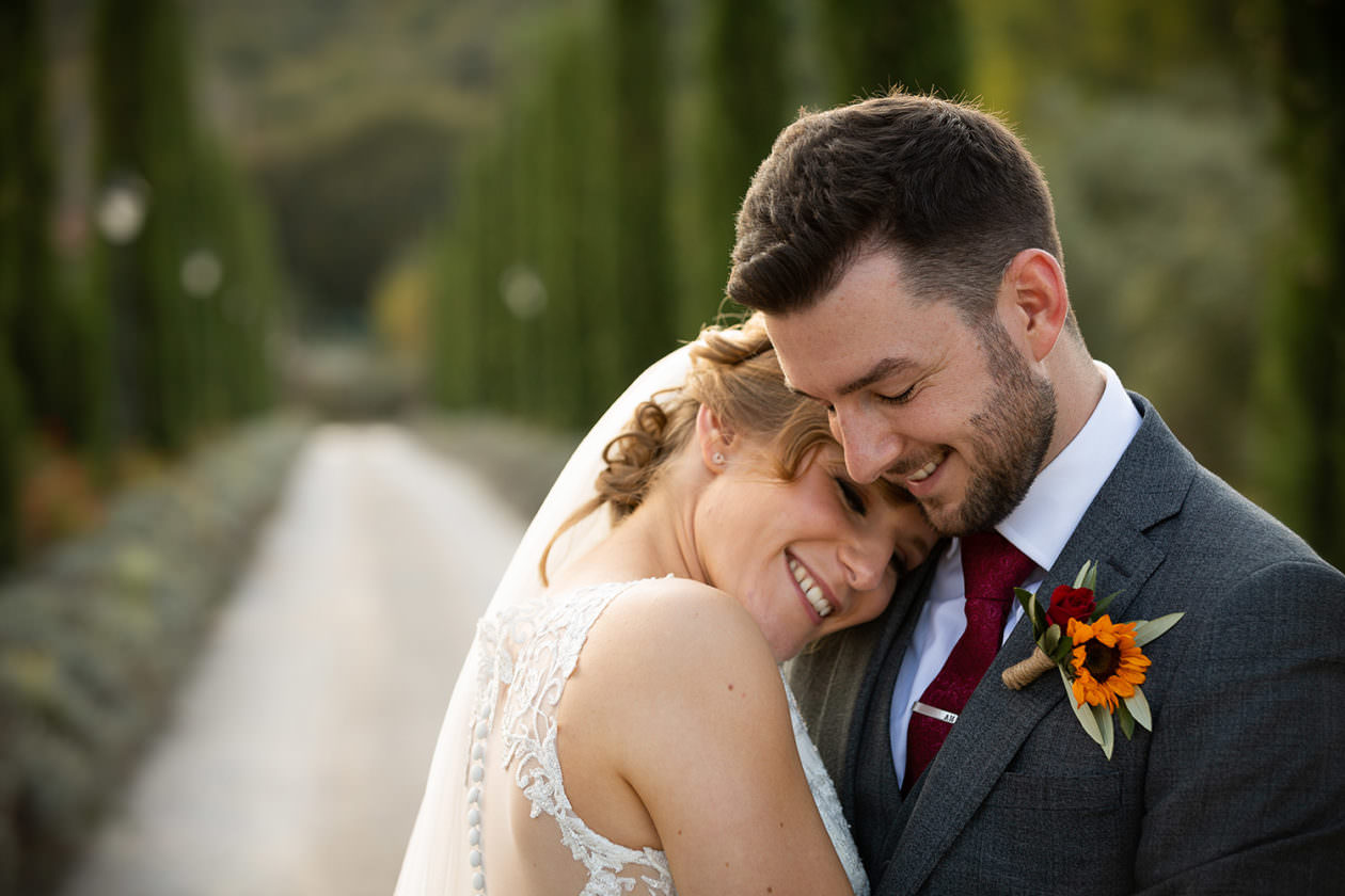 Wedding couple hugging on drive at Villa Baroncino