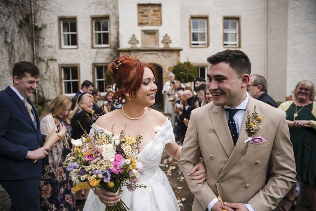 Bride looking into the grooms eyes at their wedding at Lartington Hall. Both are very happy and smiling.
