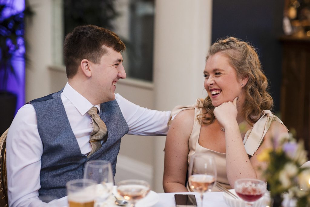 Guests sitting at the wedding tables and having fun.