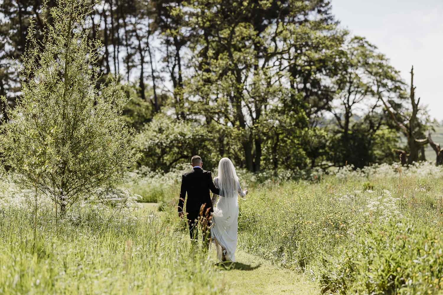 Wedding couple walking in the gardens of Le Petit Chateau.