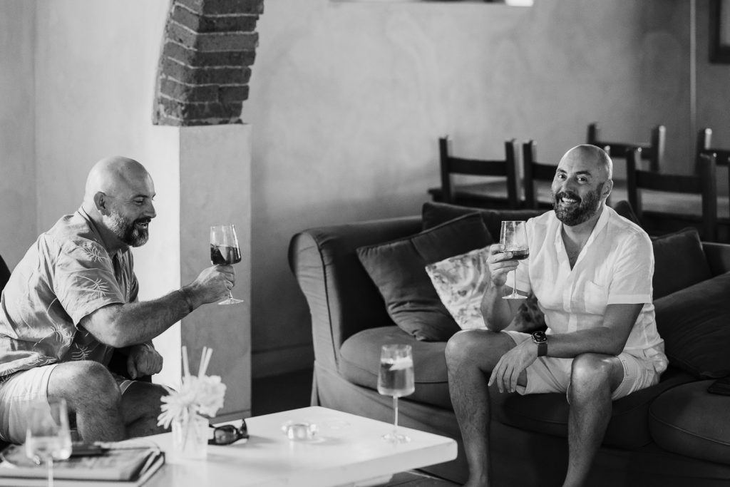 Groom having a drink with the best man.