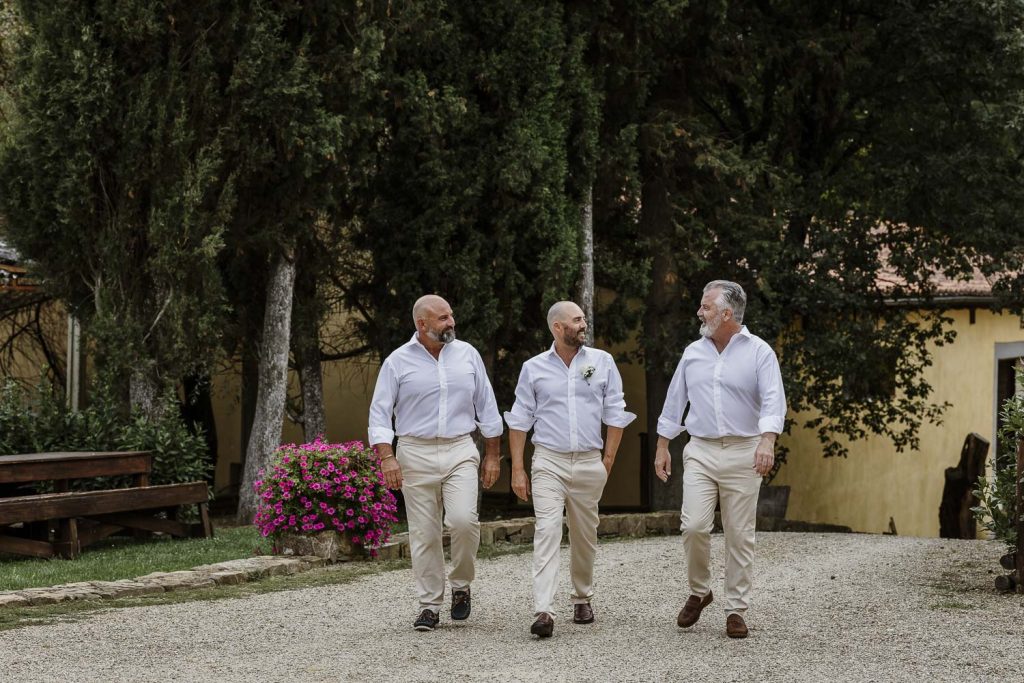 Groom and best men walking to Tenuta Romignano to get married.