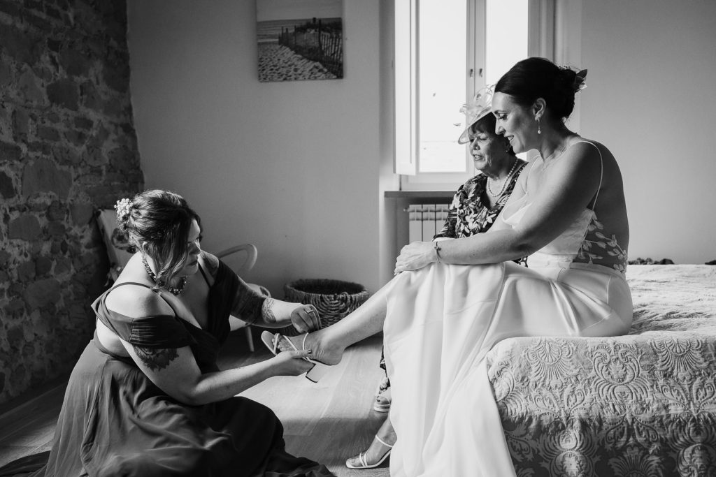 Bride putting on her shoes before her wedding.
