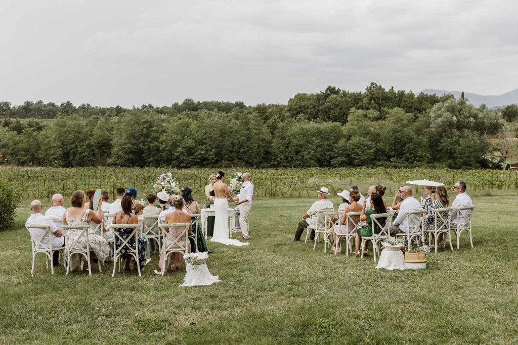 Outdoor wedding ceremony in the gardens of Romignano Wine Farm.