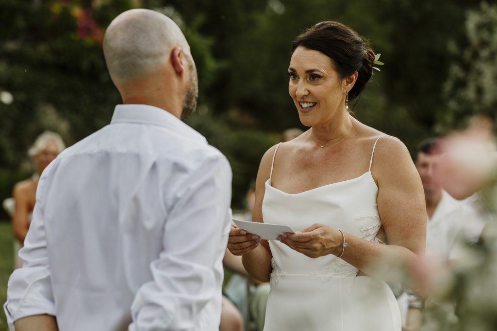 Bride giving her vows at their outdoor wedding ceremony at Romignano Wine Farm.