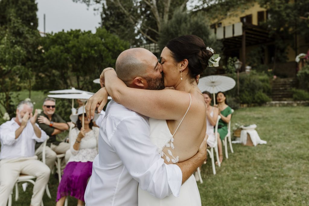 First kiss with bride and groom on their wedding day.