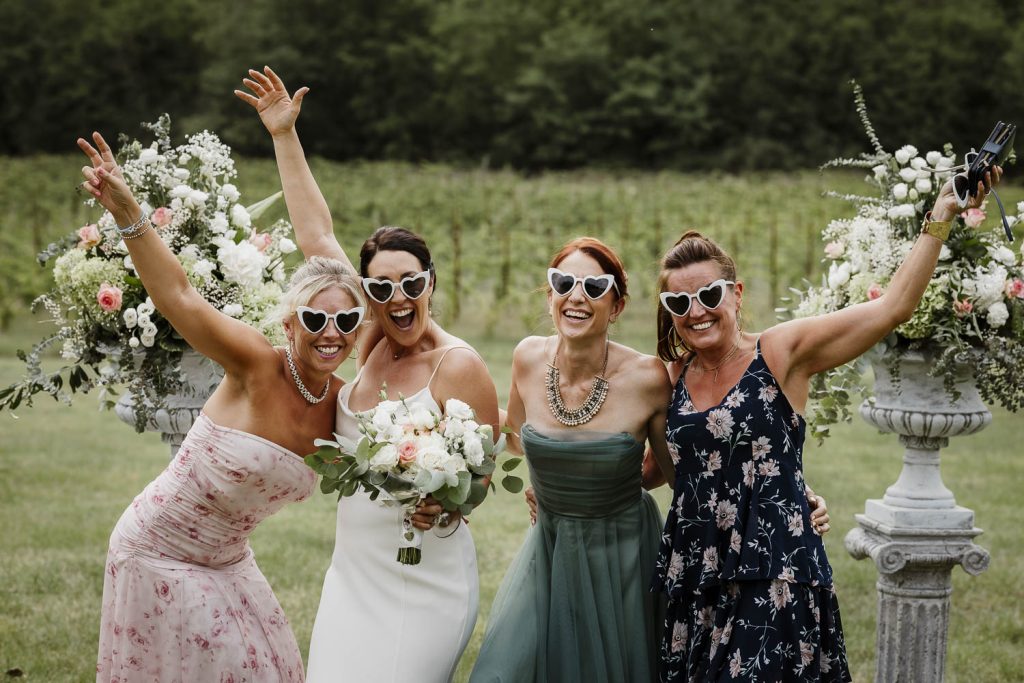 Bride having fun with her bridesmaids on her wedding day.