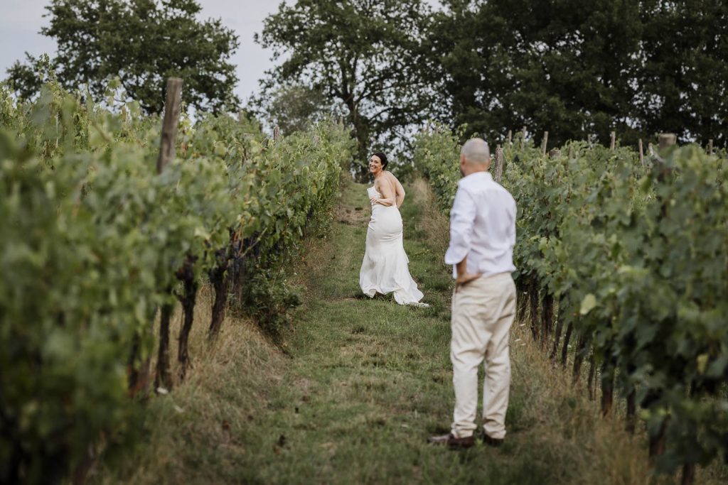 Bride and groom having fun on their wedding day in the vineyard.