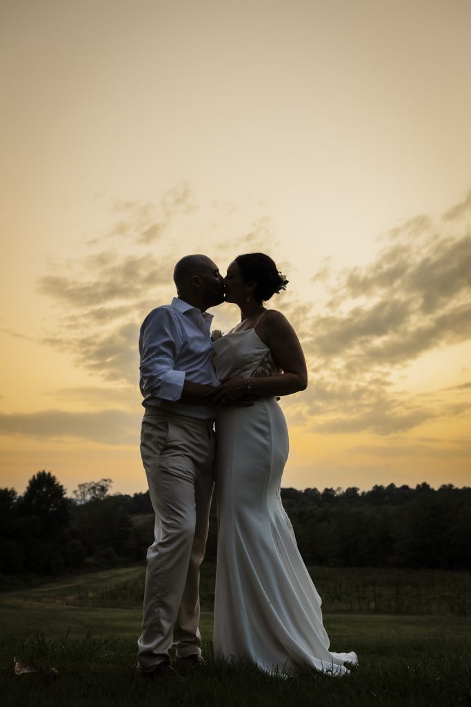 Bride and groom embracing at sunset on their wedding day at Tenuta Romignano.