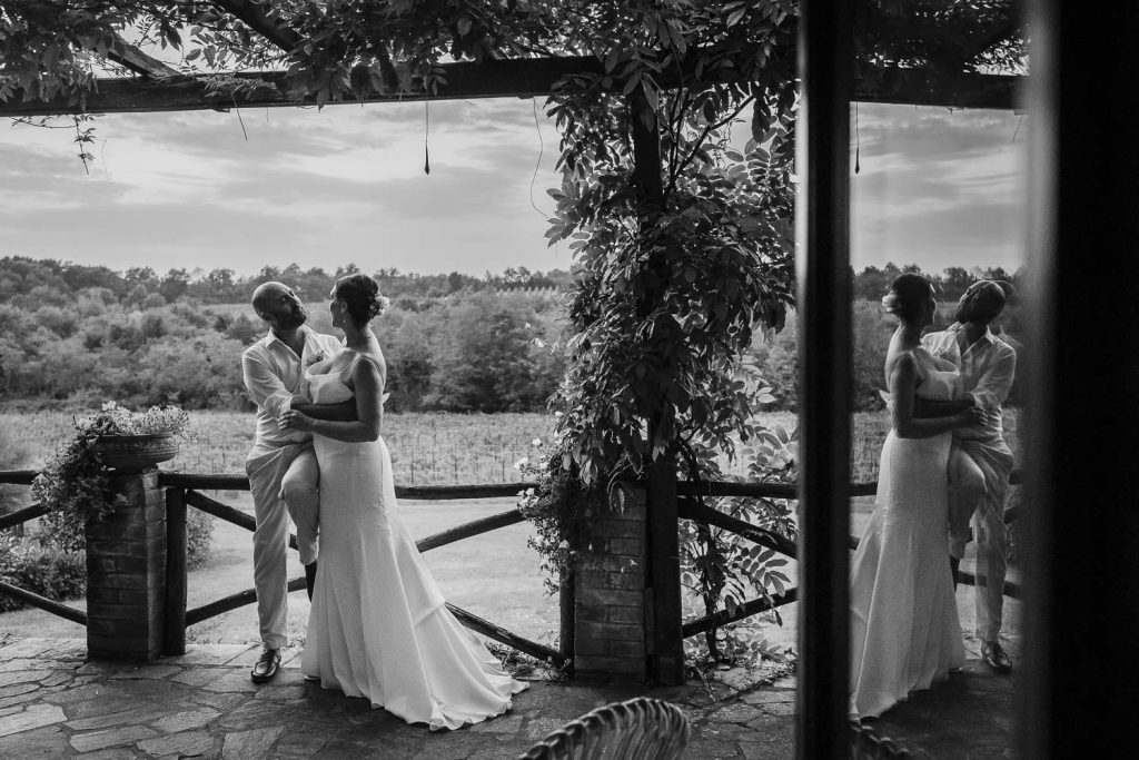 Bride and groom on the patio of one of the villas at Romignano wine farm on their wedding day.