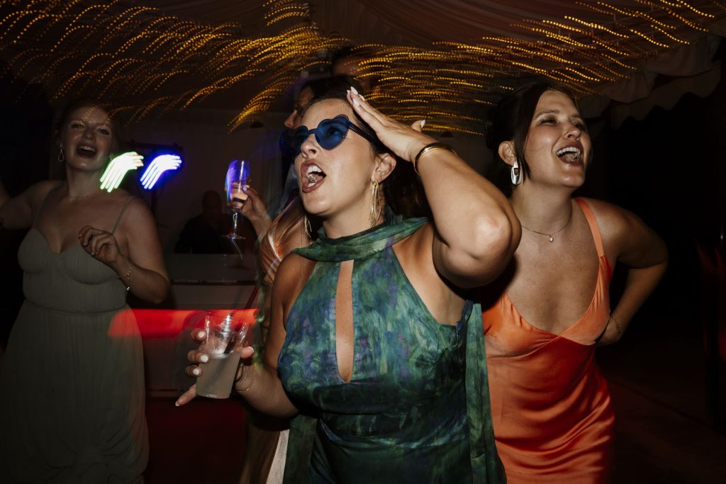 Wedding guests dancing on the dance floor at a wedding at Villa San Crispolto.