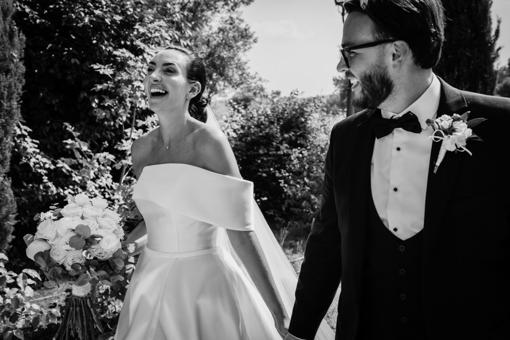 Bride and groom walking up their wedding venue drive very much in love.