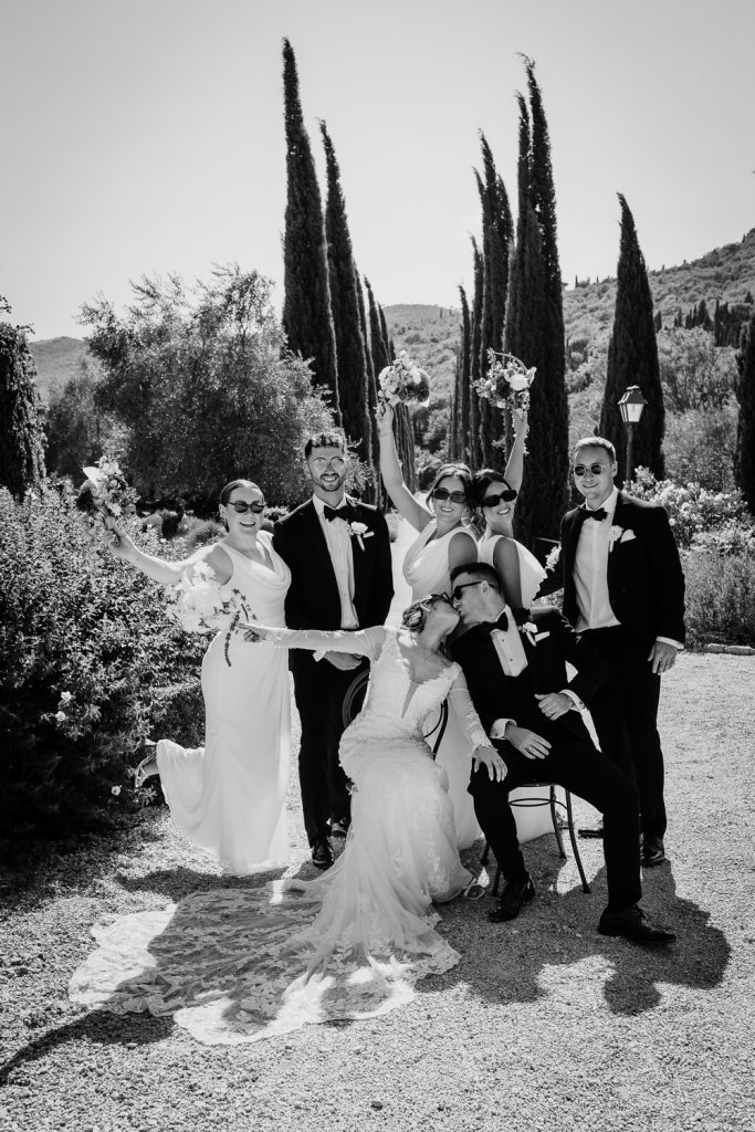 Editorial wedding photo of bridal party standing together on the driveway of Villa Baroncino